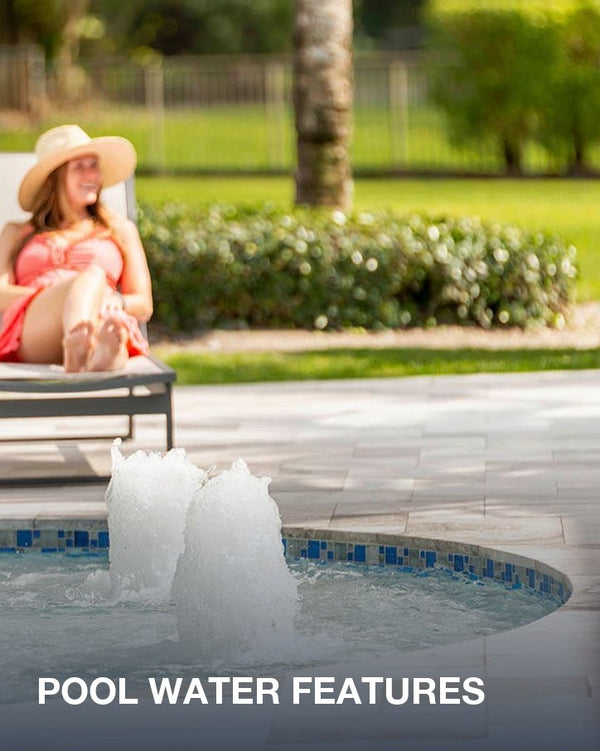 Pool water features: two bubblers in a tiled spa, a woman relaxing on a lounger behind