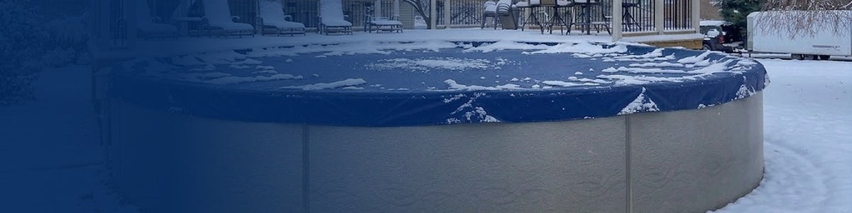 Solid blue winter cover on a round above ground pool in the snow