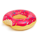 Giant strawberry frosted donut pool float on the water