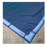 Blue solid winter cover installed over a rectangular inground pool