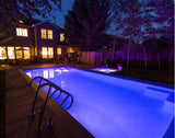 Pool lit at night by S.R. Smith LED lighting run from a poolLUX control system