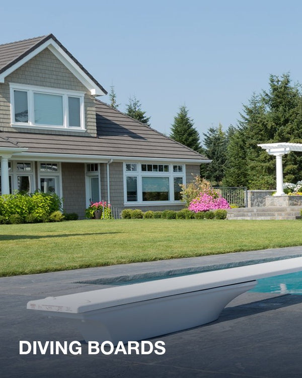 Diving boards: a white diving board over a backyard pool